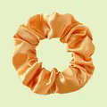 Elastic satin scrunchie in glossy orange-gold fabric with a rich pleated texture - Orange Gold