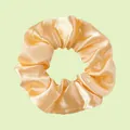 Elastic champagne gold satin scrunchie with a glossy pleated texture and elegant design - Light gold