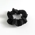 Elegant solid black satin scrunchie with a glossy silk-like finish and soft pleats - Black