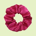 Vibrant hot pink satin scrunchie with a glossy silk texture on a pale green background - Rose Pink