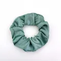 Elegant sage green satin scrunchie with smooth silk texture and soft fabric folds - Satin 24