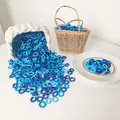 Close-up of bulk elastic blue hair ties in a decorative basket for gentle hair styling - Blue Series
