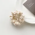 Detailed close-up of cream-colored plush scrunchie showing soft fleece texture and pleats - Off White