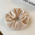 Detailed texture of a beige velvet scrunchie with natural soft folds on white background - Beige
