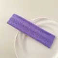 Close-up of purple terry cloth sports headband with soft texture on a white tray - Purple