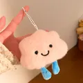 Close-up of pink plush cloud keychain with embroidered smile and striped blue limbs - Hanging Chain Style / Pink