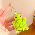 Close-up of a soft green plush turtle keychain with detailed shell embroidery and bead chain - Green Little Turtle / Light Green
