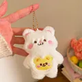 Detail of white plush bear pendant with pink blush and yellow pocket embroidery - Bear with Yellow Pocket (Style Four) / White