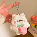 Detailed macro of white plush cat keychain featuring a pink woven bag and silver ring - Cat with Pink Knitted Bag (Style One) / White