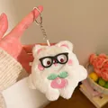 Close-up of cute plush bunny keychain with strawberry embroidery and silver keyring - Black Frame Glasses Strawberry Bear (Style Three) / White