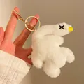 Detail showing the plush white duck keychain with golden metal clasp held in hand - Small (With Keychain) / White