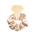 Close-up of champagne satin scrunchie on elegant display card with gold trim details - Apricot