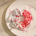 Detail of strawberry print hair scrunchie with red plaid fabric and lace trim bow - Red Plaid and Strawberry Pattern with Lace