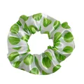 Detail of white satin scrunchie with green tennis ball print and smooth silky texture - White Tennis Ball