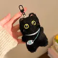 Close-up of black plush cat keychain with yellow eyes and a small fish charm detail - Fish Backpack Style