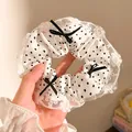 Detailed lace trim and polka dot pattern on the fabric scrunchie with tiny black bows - White Polka Dot