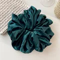 Close-up of oversized dark green satin scrunchie showing premium pleated silk texture - Dark Green