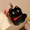 Detail of a fluffy black plush cat keychain with a red scarf and a matte metal clasp - Red Scarf Style
