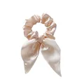 Detail of champagne pink satin scrunchie with long ribbons and silky fabric texture - Light Pink