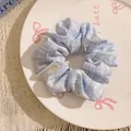 Light blue and white plaid fabric scrunchie with lace trim and star sunflower label - Blue Plaid with Flower Tag