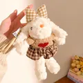 Close-up of white plush bunny keychain wearing a brown plaid skirt and a knit sweater - Style 2 / 18cm