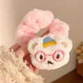 Close-up of plush scrunchie featuring a white teddy bear with blue hat and embroidery - White Bear Pink Scrunchie