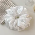 Oversized white satin scrunchie with pleated texture on a cream background - Wrinkled White