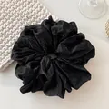 Oversized black satin scrunchie with pleated silk texture for high ponytail hairstyles - Wrinkled Black