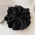 Oversized black satin scrunchie hair tie with smooth silk texture and soft folds - Black