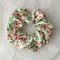 Detailed view of Christmas themed satin scrunchie with festive hat and snowflake patterns - White Christmas Hat Style (Christmas Style 8)