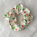 Macro shot of white satin Christmas scrunchie with festive trees and bells print - White Full Element Print Style (Christmas Style 11)