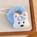 Close-up of plush West Highland dog hair scrunchie with blue hat detail on wooden tray - Scrunchie Style
