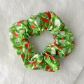 Green silk scrunchie with Christmas hat and beard pattern for festive ponytail styling - Green Santa Head Style (Christmas Style 12)