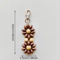 Brown and beige beaded daisy keychain charm with silver metal clasp and size dimensions - Dark Brown