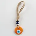 Orange Evil Eye hanging ornament with gold beads and rustic jute rope loop - Orange