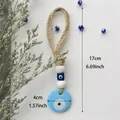 Handgefertigter Evil Eye Wandbehang mit blauem Glasanhänger und Jutieseil 17cm - Hellblau