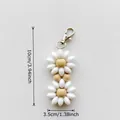 White and wood bead floral keychain charm with lobster clasp measuring 3.94 inches - White