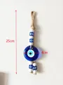 Handgefertigter Evil Eye Wandbehang mit 4cm Glasperle und 25cm langem Juteseil - Blaues Auge Anhänger