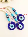 Blauer Evil Eye Wandbehang mit türkisen Perlen und Juteseil, Länge 25 cm und Durchmesser 6 cm - Blaues Auge Anhänger