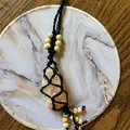 Handmade woven Himalayan salt stone wall hanging with evil eye and wooden beads decor - Black