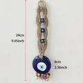 Handmade woven hemp Evil Eye wall decor with blue beads and a 6cm glass pendant - Hemp Rope Colored Beads Evil Eye Hanging