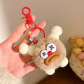 Brown plush monster keychain with fuzzy texture and colorful letter beads on a ring - Brown