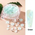 Mint green sun flower nail charms with silver beads in a transparent storage box - Green
