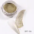 Macro shot of fine gold chrome nail powder with sample swatch and plastic jar container - Gold Glitter (S97-06)