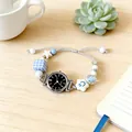 Detail of quartz watch bracelet with blue charm beads and woven rope on wooden desk - Silver Black Dial (Strip Markers)