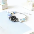 Minimalist quartz bracelet watch with blue star charm and woven strap on a soft background - Silver Black Dial (Roman Numerals)