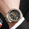 Macro shot of bicolor stainless steel watch band and chronograph dial with date display - Two-tone (Gold & Silver)