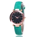 Detailed view of women star dial watch with teal leather strap and faceted gold case - Green