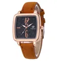 Detail view of square rose gold watch with black starry dial and brown suede strap - Khaki