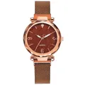 Detalle de reloj de cuarzo oro rosa con esfera estrellada y cristal facetado de lujo - Café